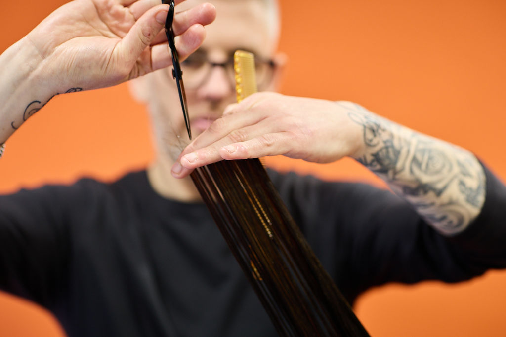 Noel cutting a client's hair at NOCO Hair