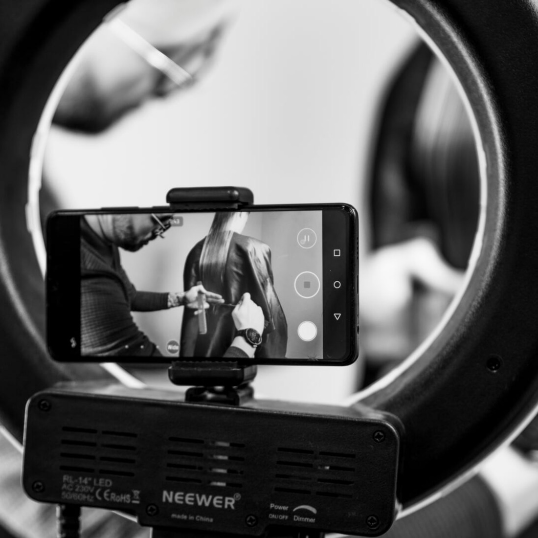 Noel cutting, seen through a ring light while filming a lesson
